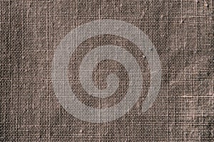 Fabric texture. Fabric background. Texture of rough brown fabric. Macro image from canvas