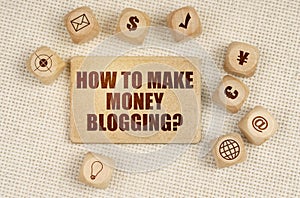 On the fabric there are cubes with drawings and a sign with the inscription - How To Make Money Blogging