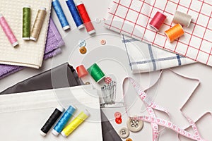 Fabric and threads on a gray background.Sewing tools and accessories