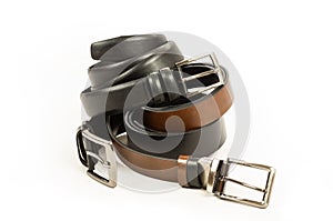 Fabric trousers and jeans genuine and faux leather black and brown belts isolated on white background
