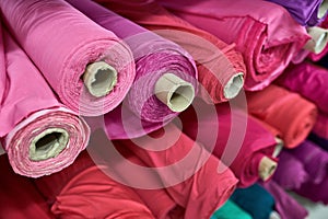 Fabric warehouse with many multicolored textile rolls