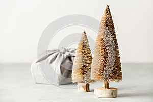 Fabric wrapped gift and coconut fiber Christmas trees