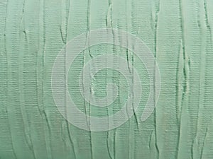 fabric wrinkled with paint in green, textured background