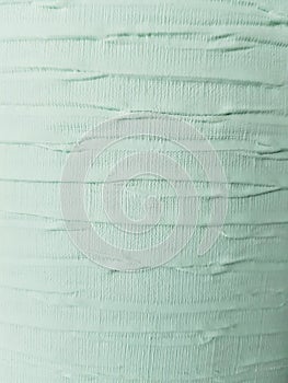 Fabric wrinkled with paint in green, textured background