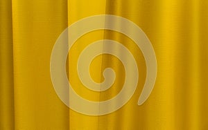 Fabric yellow curtains. Abstract background, curtain, drapes gold fabric. Crumpled cloth, folds of fabric