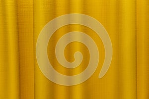 Fabric yellow curtains. Abstract background, curtain, drapes gold fabric. Crumpled cloth, folds of fabric