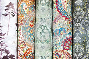 Fabricate silk and cloth on the shop shelf, multicolor pattern, rolled silk in the market