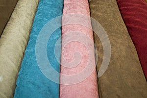 Fabricate silk and cloth on the shop shelf, rolled silk in the market, multicolor and many pattern texture background photo
