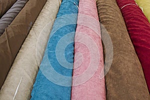 Fabricate silk and cloth on the shop shelf, rolled silk in the market, multicolor and many pattern texture background photo