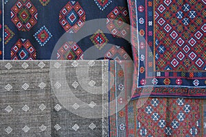 Fabrics decorated with embroidered patterns are sold at the market of a village near Gangtey (Bhutan)