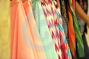 Fabrics with various colors are arranged neatly vertically