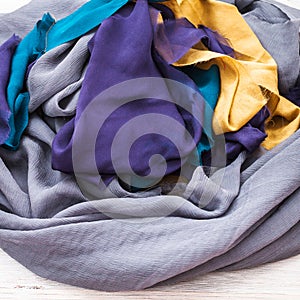 Fabrics of wrapped sewn but not yet hemmed scarf