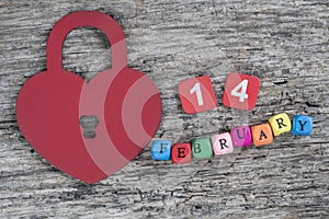 Fabruary cube calendar and heart lock on wooden background for valentines day