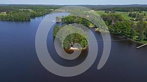 Fabulous aerial top view flight drone. Summer Paradise Wooded Island in Lake