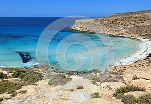 fabulous blue and turquoise sea with a beach with bathers on the coast of the island