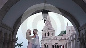 Fabulous couple in love softly embracing at the magnificent castle in Budapest, Hungary. Honeymoon concept