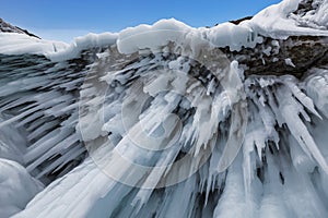 Fabulous ice icicles on the rocks of lake Baikal. Eastern Siberia,