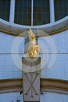 Golden Fenix statue and pax christi symbol, sign photo