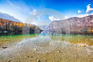 Fabulous view  of  Bohinj Lake with boats during autumn