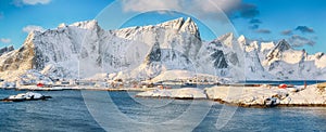 Fabulous winter view of Reine and Sakrisoya villages  seen from Hamnoy and snowy mountaines in background