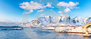 Fabulous winter view of Reine and Sakrisoya villages  seen from Hamnoy and snowy mountaines in background