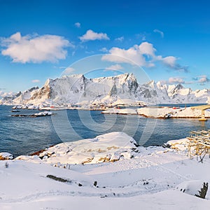 Fabulous winter view of Reine and Sakrisoya villages  seen from Hamnoy and snowy mountaines in background