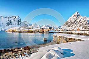 Fabulous winter view of Sakrisoy village and snowy mountaines on background