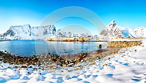 Fabulous winter view of Sakrisoy village and snowy mountaines on background