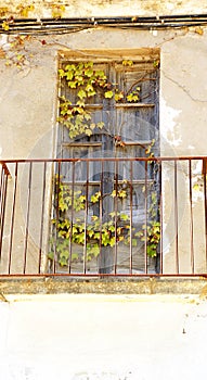 Facade with abandoned balcony in Sant Feliu de Guixols