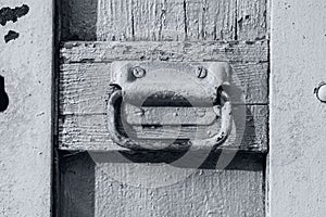 Facade of an abandoned building. Old-fashioned front door of trendy ultimate gray color