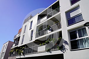 Facade apartment building with many windows balcony against blue sky