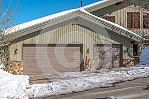 Facade of an attached garage with gray doors and gable roof in Park City Utah