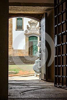 Facade of a baroque church seen from inside a historic prison