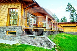 Facade of a beautiful wooden house with green garden