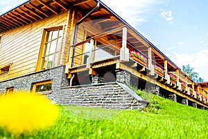 Facade of a beautiful wooden house with green garden