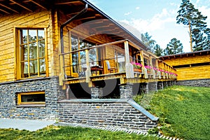 Facade of a beautiful wooden house with green garden