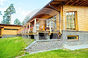 Facade of a beautiful wooden house with green garden