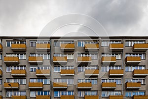 Facade of big block of flats with orange balconies