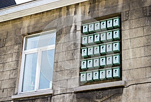 Facade of bilding with birdhouses in window in Ghent, Belgium photo