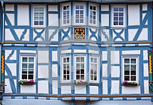 Facade of a blue half-timbered house