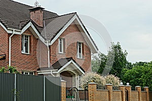 facade of a brown brick private house with windows