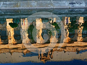 Facade of Bucharest courthouse reflected in the water of Dambovita river