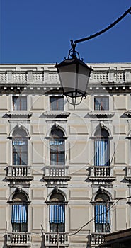 facade of the building with awnings with blue and white stripes, Venice, Italy