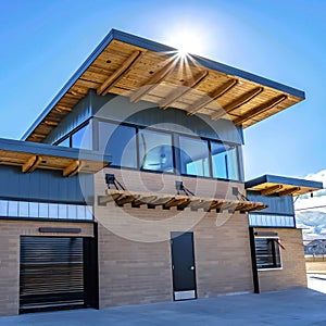 Facade of building with flat roof and brick wall against blue sky on a sunny day