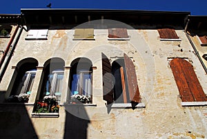 Facade of a building with flowers in Oderzo in the province of Treviso in the Veneto (Italy)