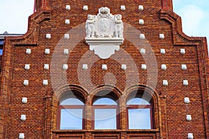Facade of building made of brick and decoration of stone shells, Leon Spain. photo