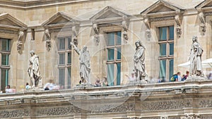 The facade of a building with male statues in the vicinity of the Louvre timelapse, Paris, France.