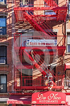 Facade of building in new york with symmetrical windows and strairs.