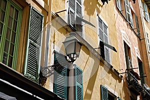 The facade of a building with a street lamp on it in Nice