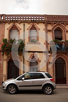 Facade and car Colonia Guell Catalonia